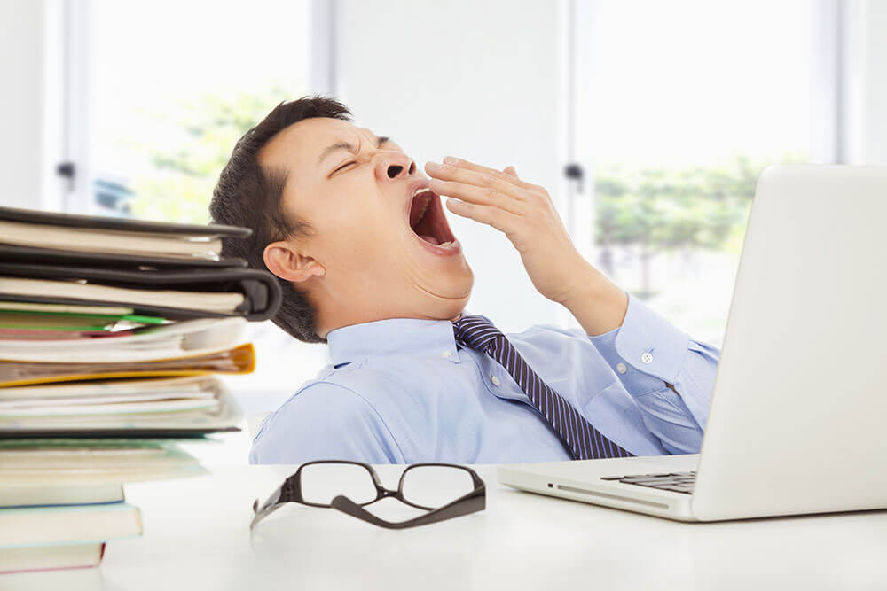 man yawning at work